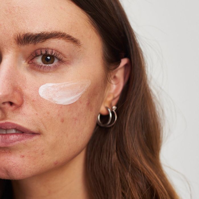 Model applying moisturizer