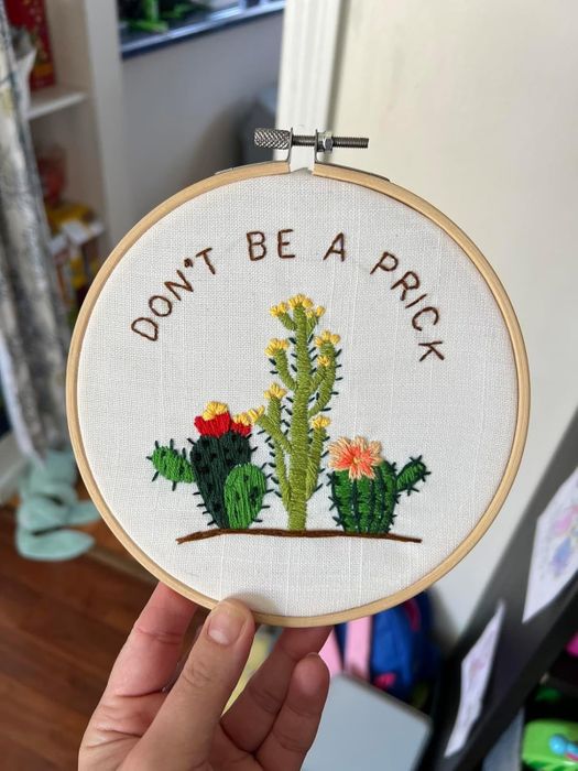 Embroidery artwork featuring various cactus designs with accompanying text