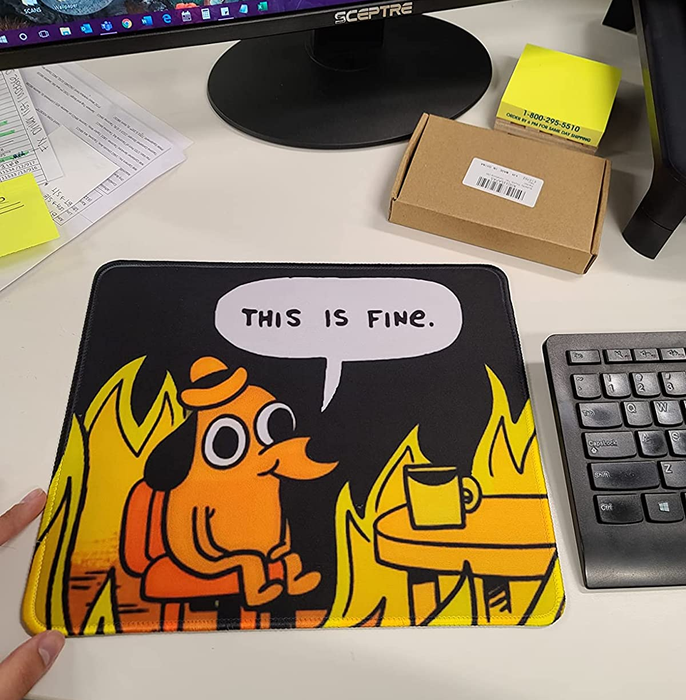 A reviewer's desk featuring the dog-in-fire mousepad
