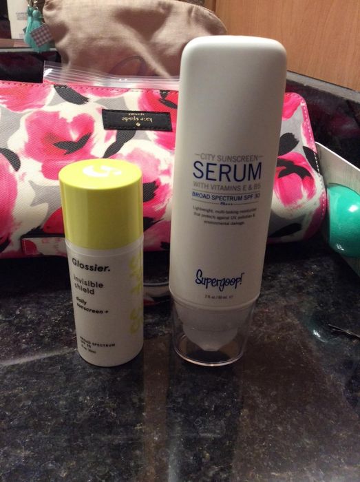 Supergoop next to a Glossier SPF