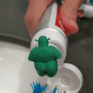 A GIF showing toothpaste being squeezed out of Shrek’s backside