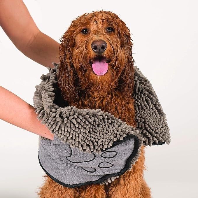A model dries a happy dog with a gray microfiber pet towel—perfect for pet owners looking for convenience and comfort.
