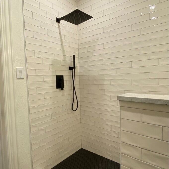The shower system includes a shower head, handheld nozzle, and precise temperature control