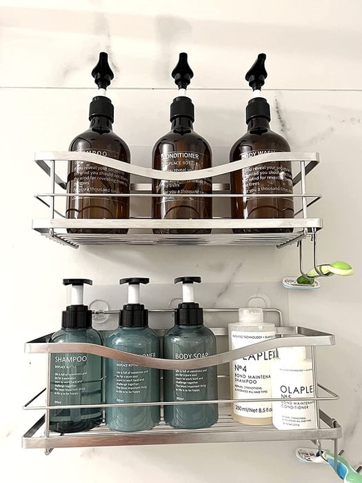 Reviewer photo of silver shelves neatly arranged with shampoo and conditioner bottles in a shower
