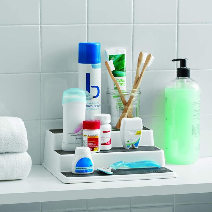 Bathroom essentials neatly arranged on a three-tier shelf