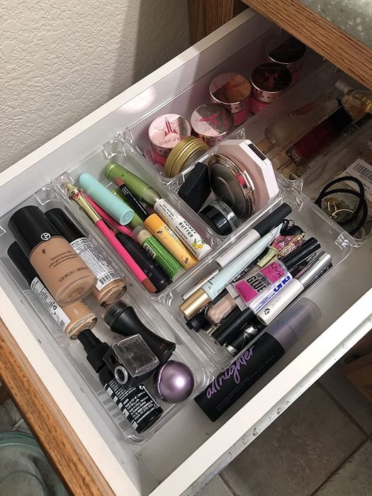 Another reviewer’s photo highlights drawer organizers efficiently storing makeup products.