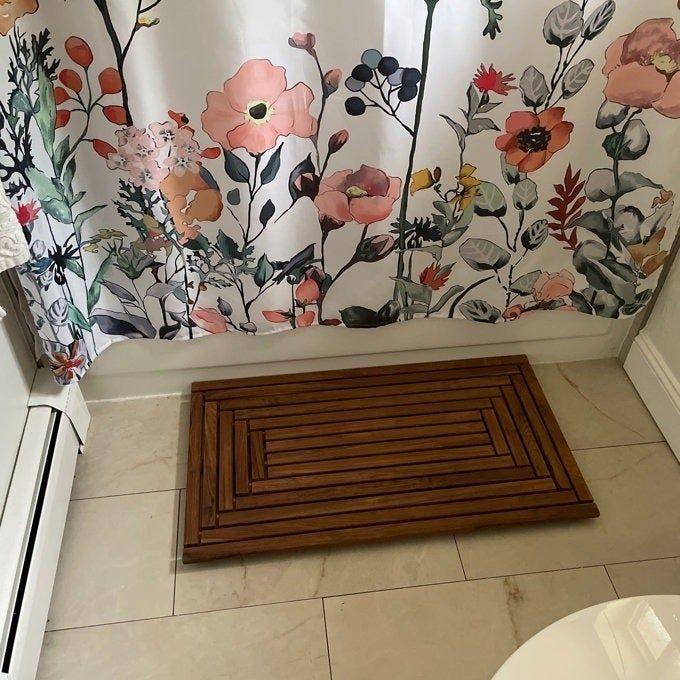 A wooden slatted bath mat designed for durability and quick drying