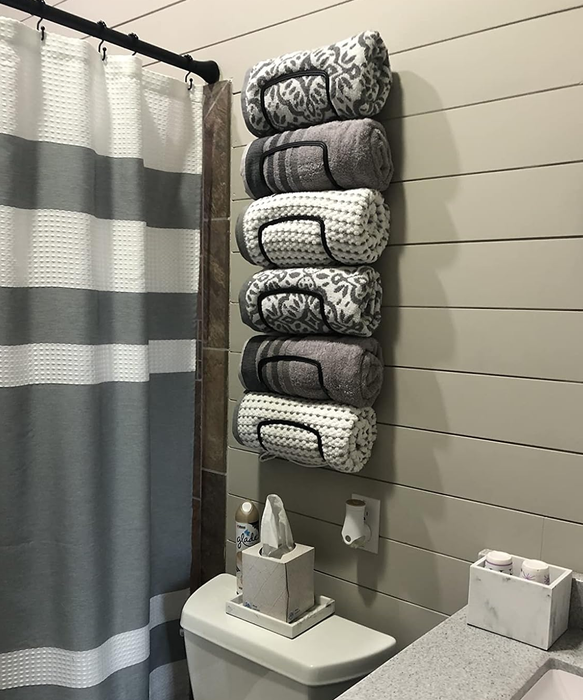 A reviewer’s mounted towel rack is displayed, efficiently holding up to six towels.