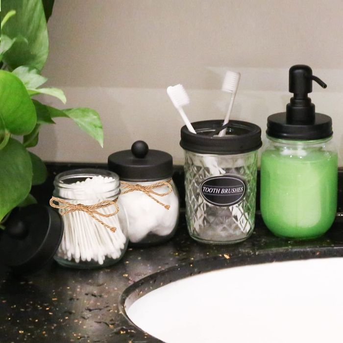 A four-piece Mason jar organization set for bathroom essentials