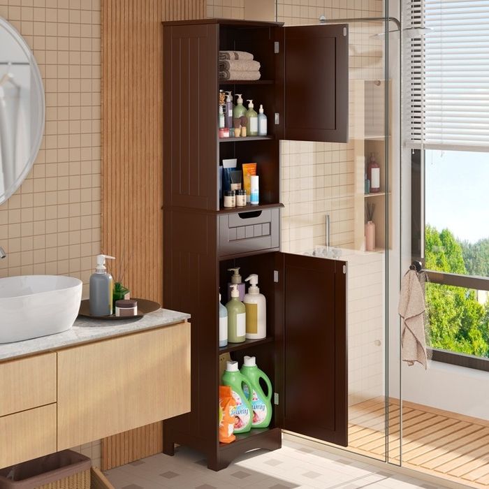 A brown bathroom storage cabinet with multiple shelves, placed in a brightly lit area