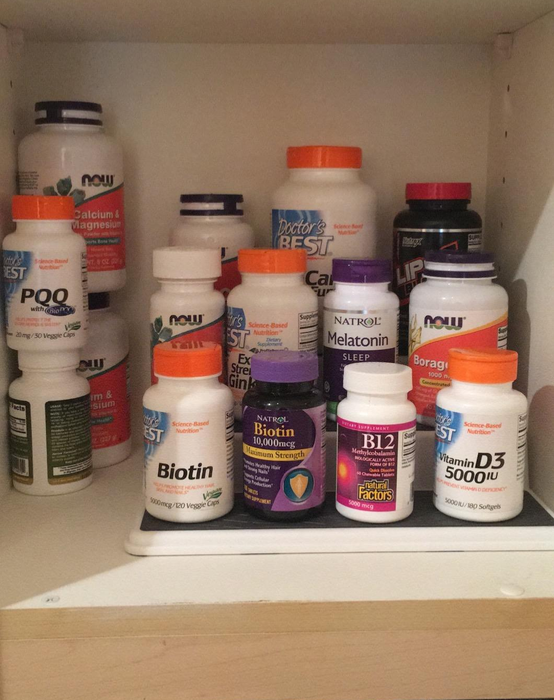 Reviewer's photo displaying supplements organized on the three-tier shelf
