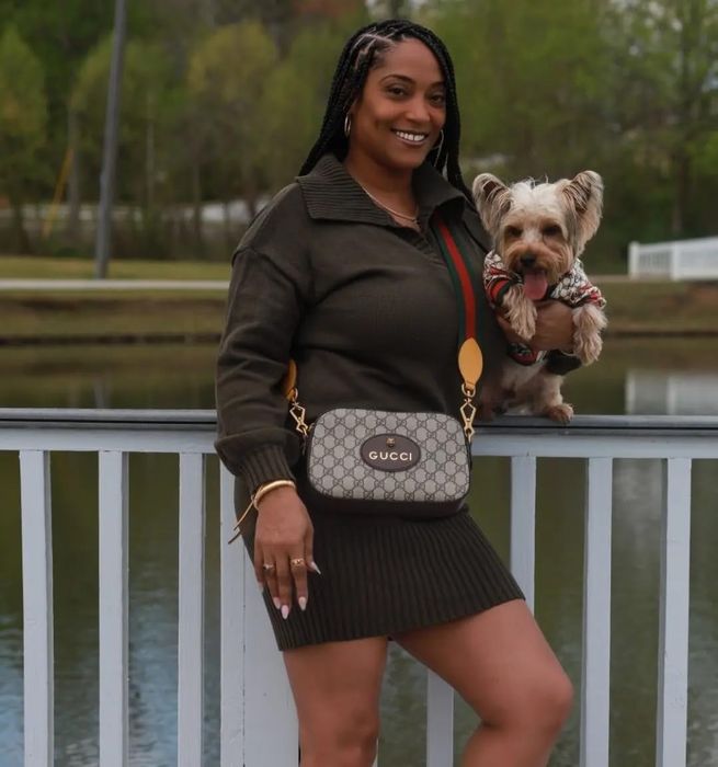 A reviewer showcases the army green dress while holding their dog.
