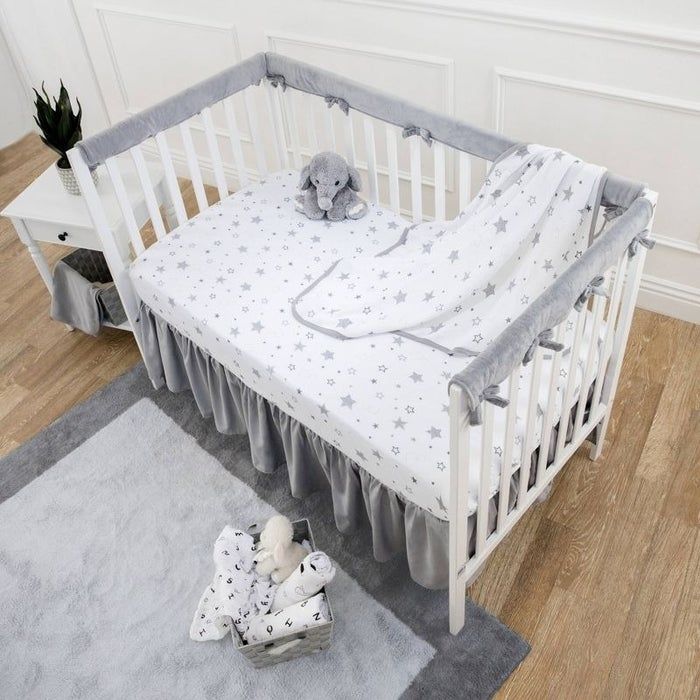 Crib rail covers installed on a crib