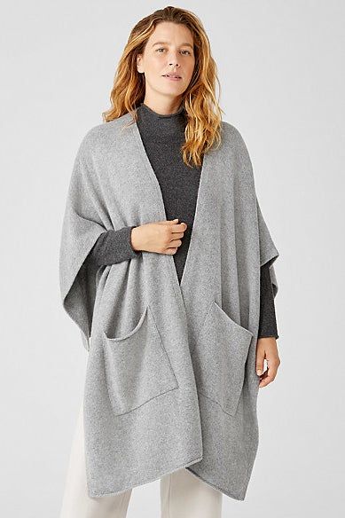A model draped in a light gray version of the wrap, embodying effortless comfort and style.