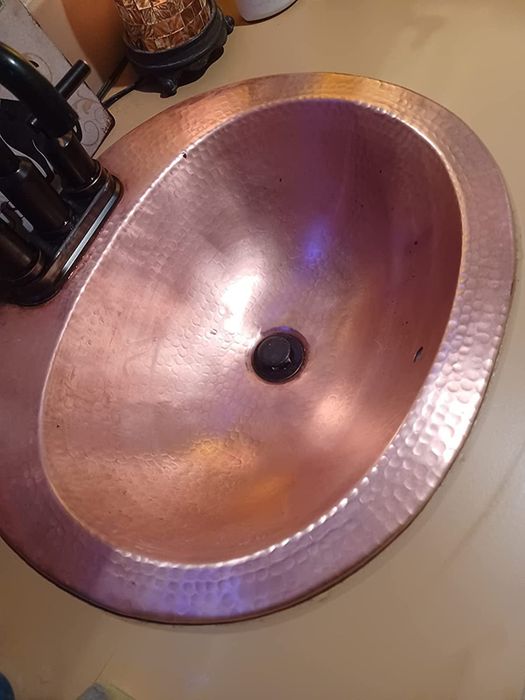 after photo showing the same copper sink looking polished and spotless