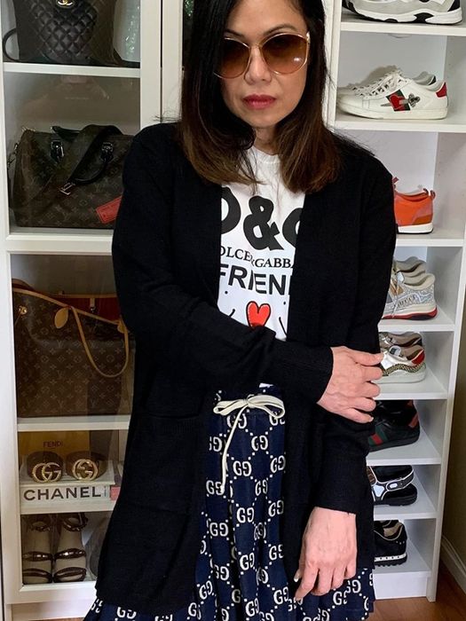 A reviewer sports the cardigan in black.