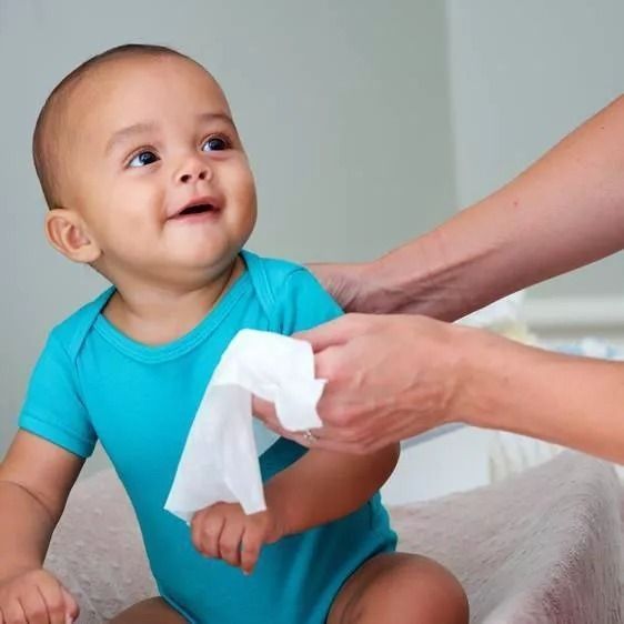 A child model has their nose wiped gently