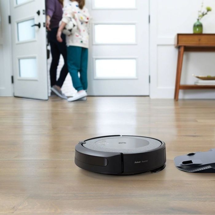 A robot vacuum cleans a floor
