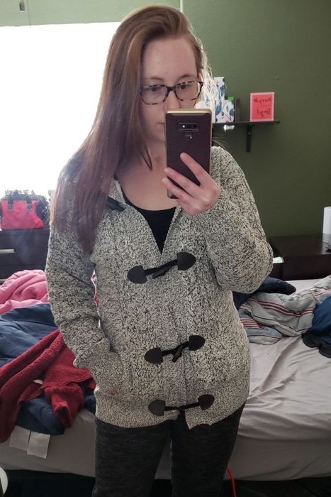 A reviewer showcases the gray version with brown clasps.