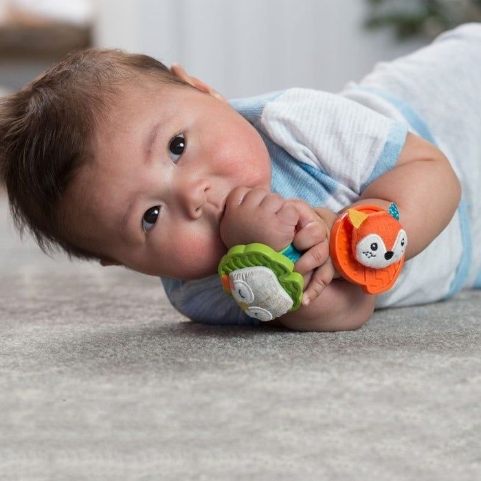 Baby wearing rattles on its wrists