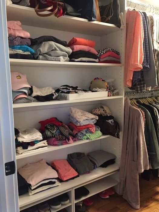A closet of clothes that are organized but slightly squished together.