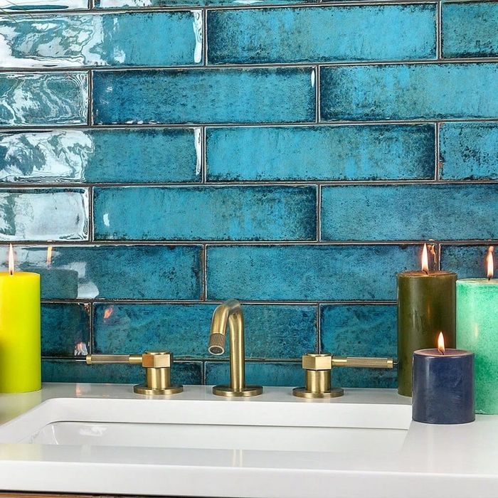 The tiles that line the wall behind a bathroom sink, adding both practicality and style.