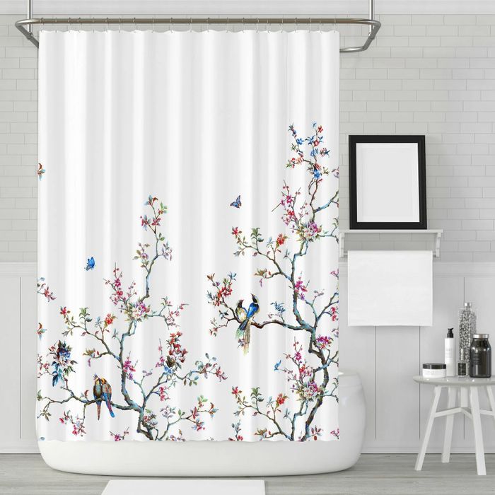 This shower curtain features a vibrant print adorned with delicate flowers and birds, adding a cheerful touch to any bathroom.