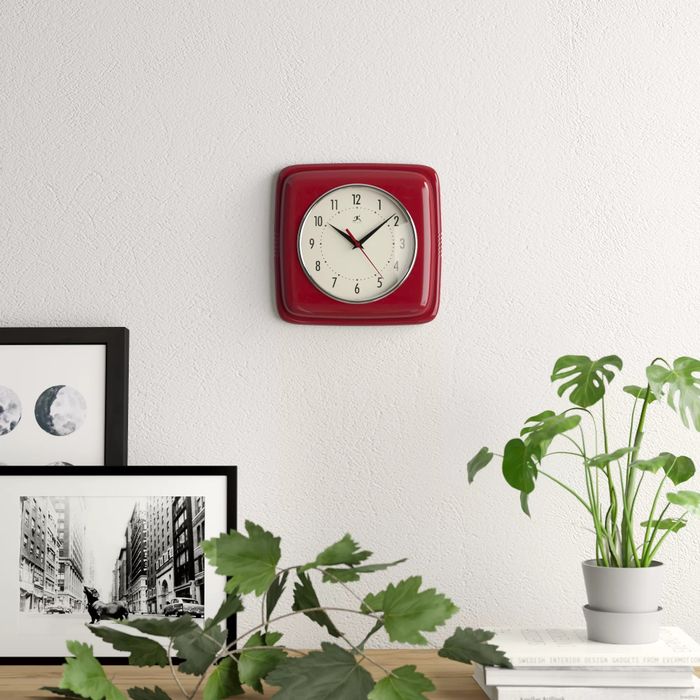 The square clock displayed on a wall