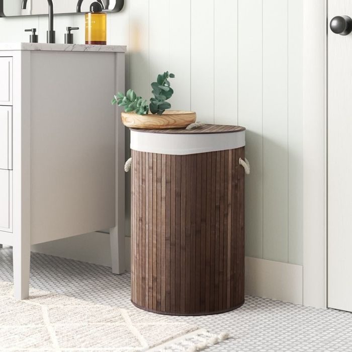 the laundry hamper placed in a bathroom