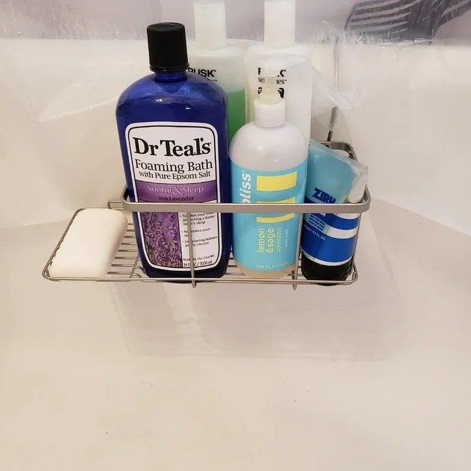 A reviewer’s photo showing the caddy placed in a bathtub, illustrating how it holds various items with ease.