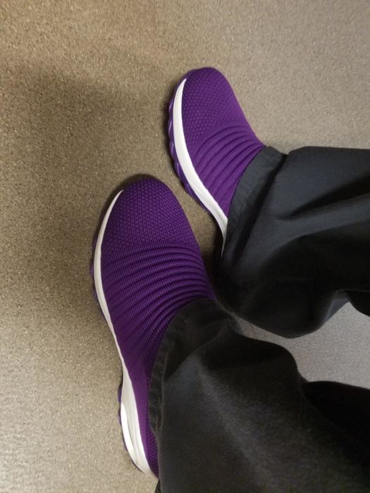 The reviewer is sporting a pair of purple slip-on shoes.
