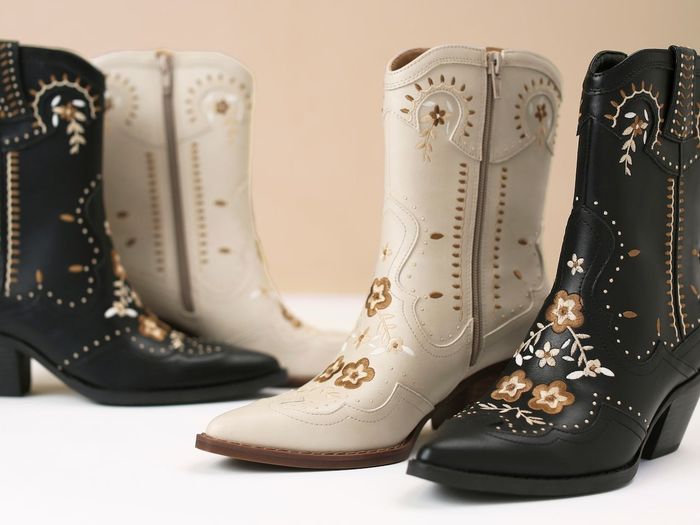 Two pairs of embellished cowboy boots elegantly displayed