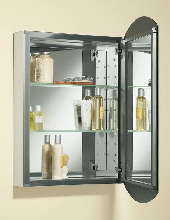 The interior of the mirrored cabinet, showcasing a mirrored surface and two adjustable glass shelves for organized storage.