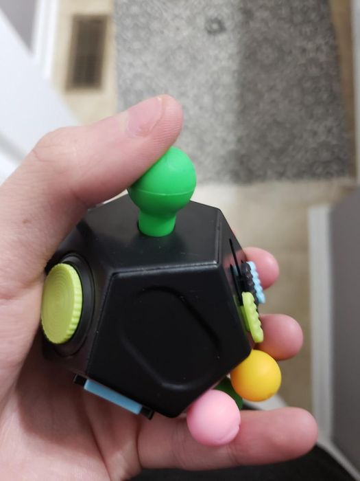 Another reviewer holding the fidget toy for display