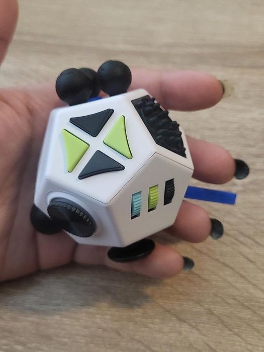 A reviewer showcasing the fidget toy in hand