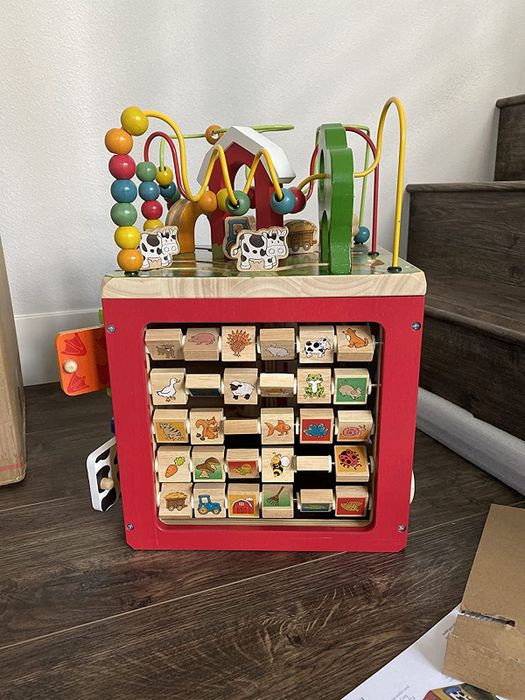 A wooden cube with various interactive features