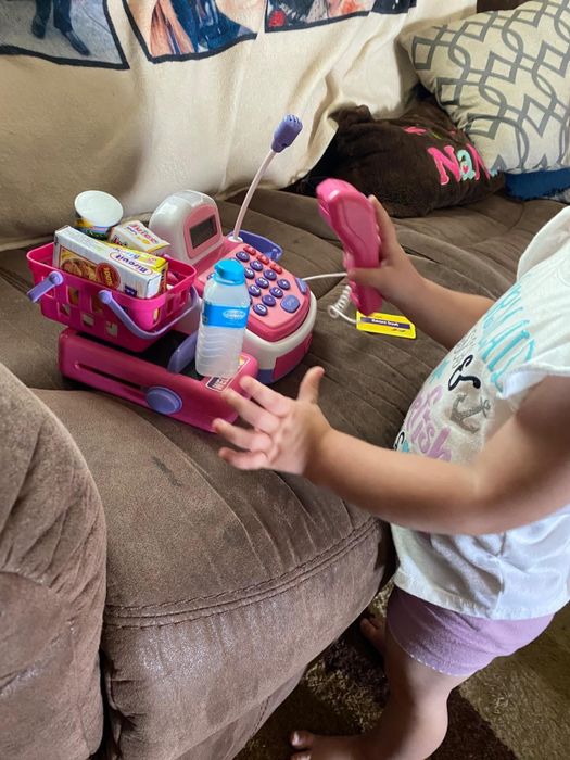A child having fun with the play set on a couch