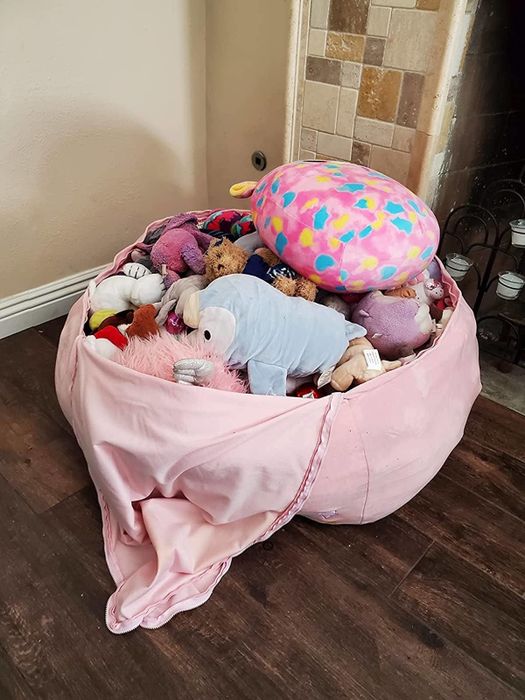 A collection of stuffed animals inside the beanbag cover