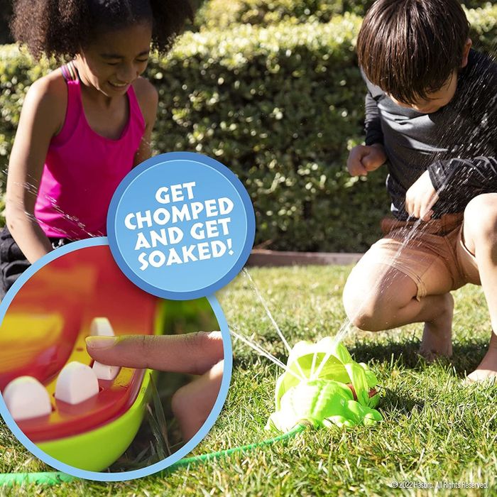 Child models getting sprayed by the crocodile toy