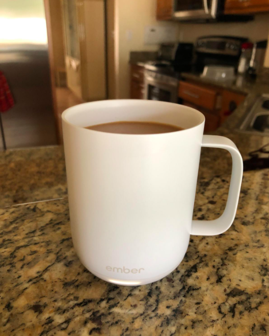 A reviewer's photo of a white Ember mug.