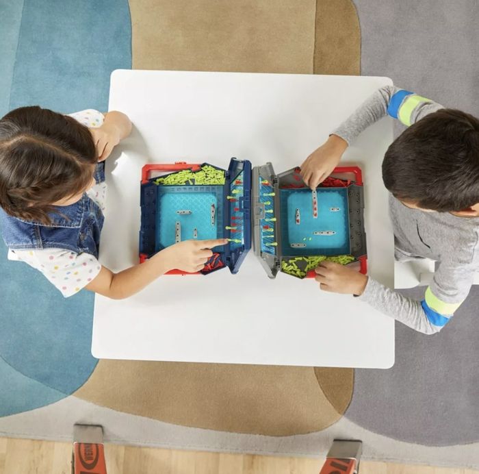 Kids playing a game of Battleship.