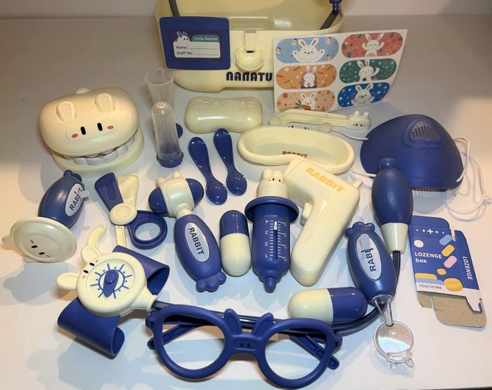 A detailed close-up of the complete contents of the toy doctor kit.