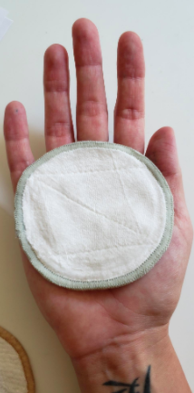 A reviewer's photo illustrating the size of the reusable makeup remover pad on their palm. Measuring 75mm in diameter, it’s roughly the size of a hand.