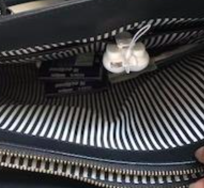 A photo from the reviewer displaying the interior of their purse with the purse light switched off.