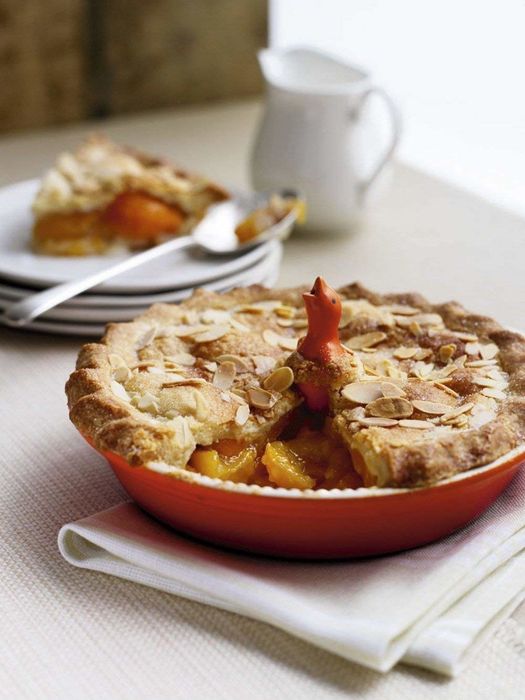 The pie bird peeking out from the center of a freshly baked pie