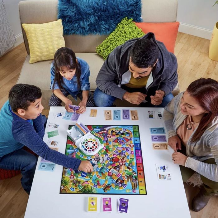 Family playing The Game of Life together.