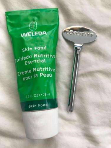 A reviewer's photo featuring a lotion tube placed beside the Magic Key.