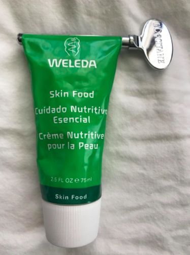 A reviewer's photo demonstrating the Magic Key in action, efficiently squeezing out the last bit of lotion from the tube.