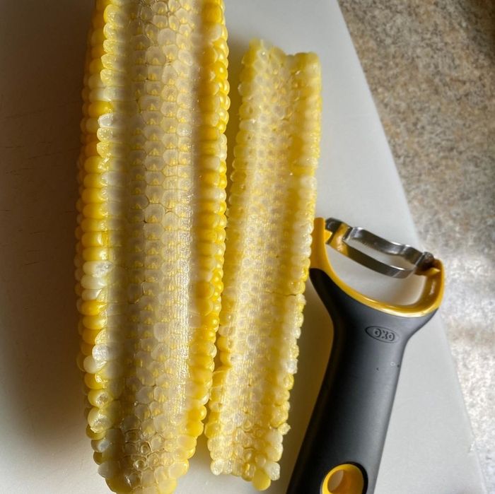 A reviewer's image showcasing peeled corn alongside the peeler used.