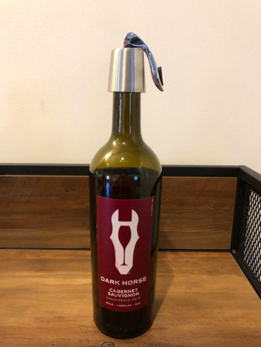 A photo from a reviewer demonstrating the wine stopper being used on a bottle of red wine.